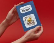a person holding the burger prize passport on a red background