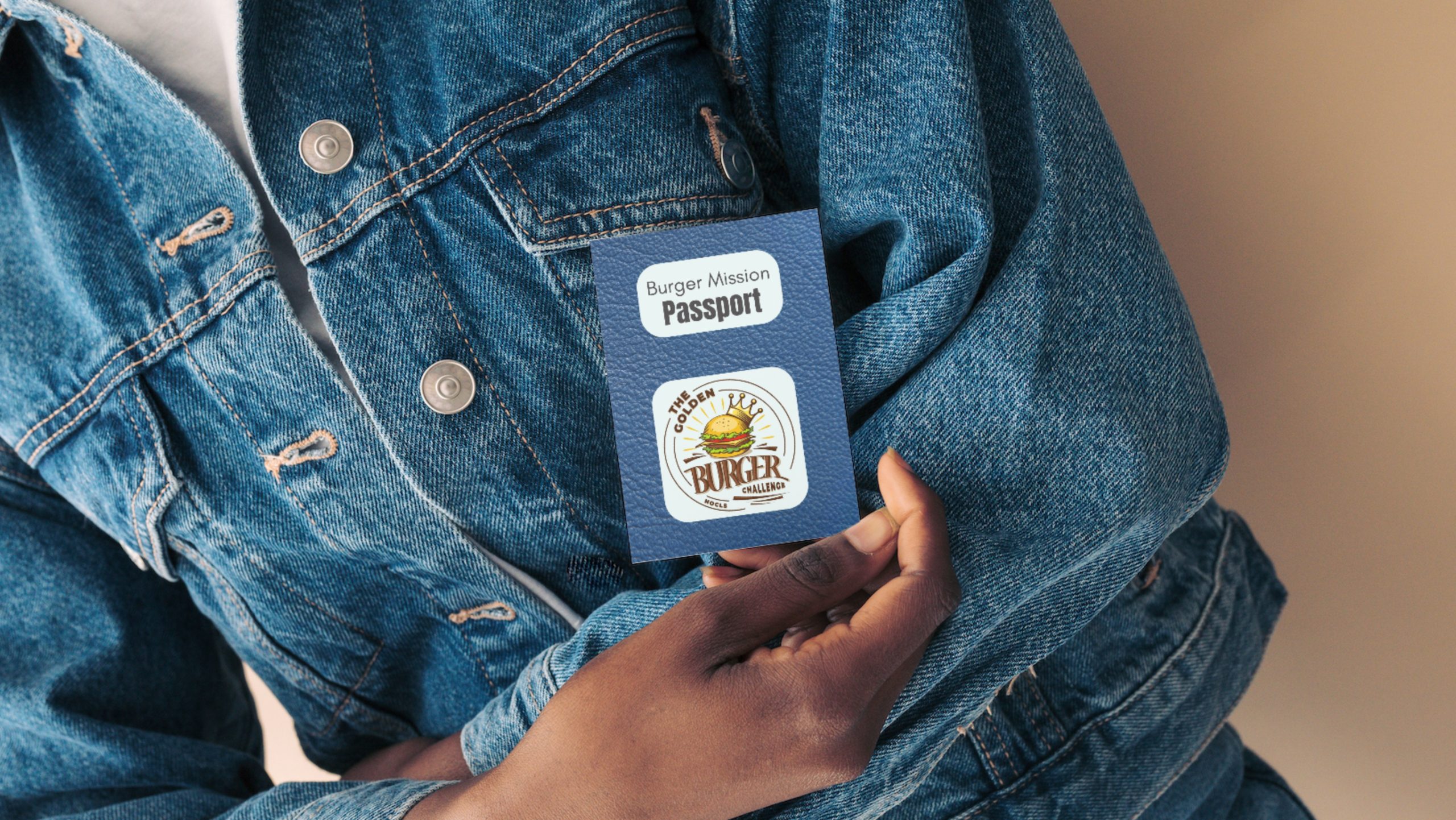 a person in a jean jacket holding a burger challenge prize passport.